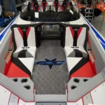 Custom boat interior featuring sleek red and white seating, luxury design, and DCB logo, showcasing high-performance craftsmanship.
