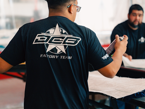 DCB factory team member working on boat construction, showcasing craftsmanship and precision in the manufacturing process.
