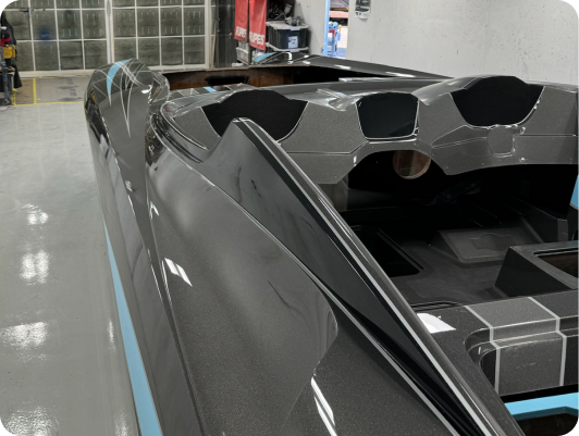 High-performance marine vessel hull with sleek composite design, showcasing top deck and bond line preparation in manufacturing process at DCB Performance Marine.