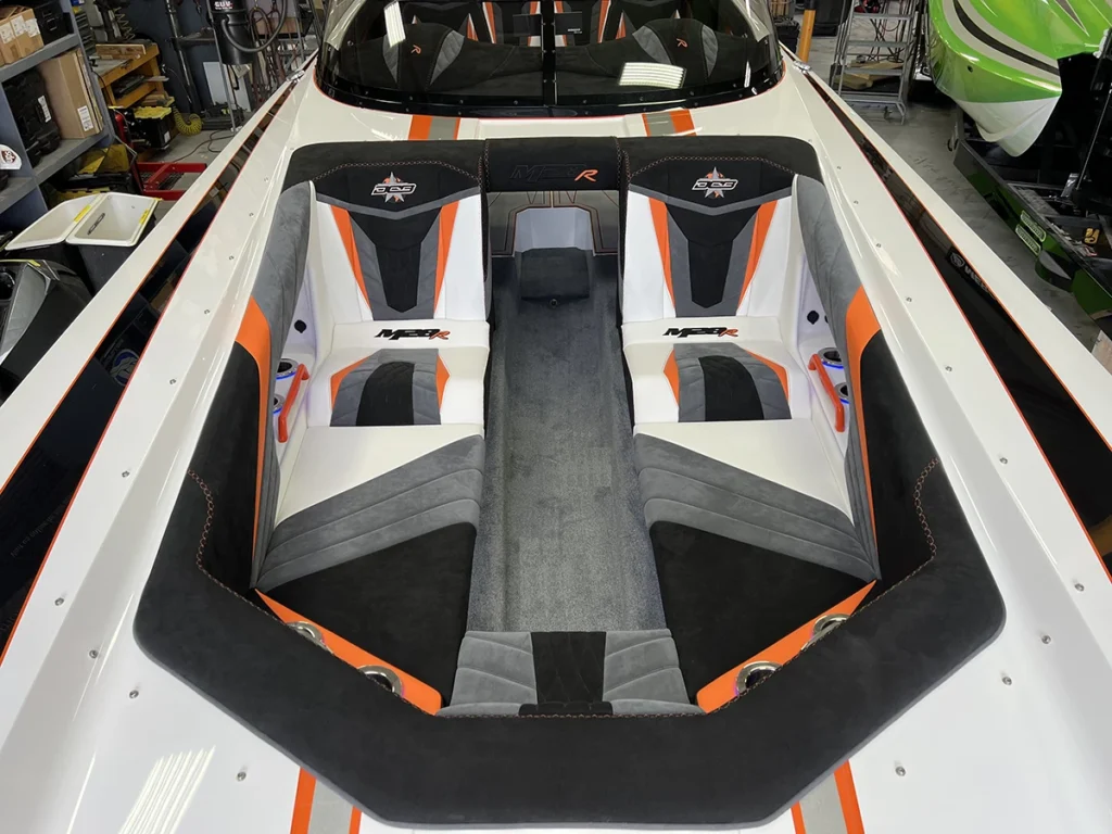 Full-Windshield Open Bow seating arrangement in DCB M28R, featuring custom upholstery, spacious layout, and wind protection for enhanced comfort on the water.