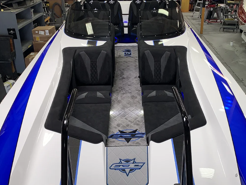 M31 Walkthrough Open Bow interior featuring sleek seating arrangement, custom upholstery, and DCB branding, designed for family-friendly cruising and easy movement on the water.