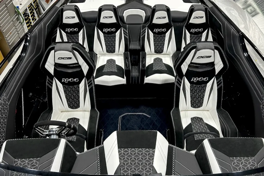 Interior of DCB M44 performance boat featuring custom black and white upholstery, ergonomic seating, and high-quality craftsmanship, emphasizing comfort and style.